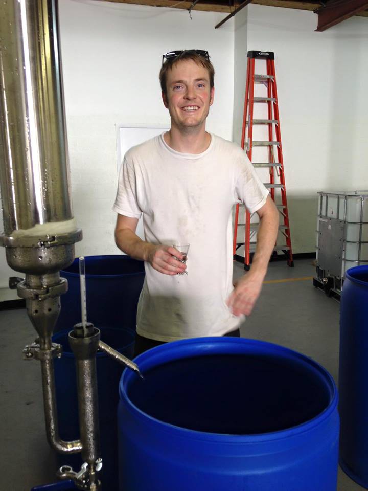 Photo of A.J. Fazendin with a batch of his new gin.