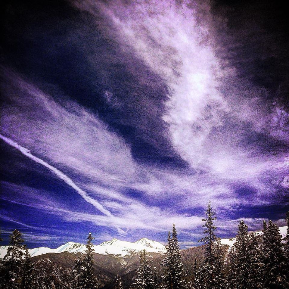 Photo of snowy Colorado peaks and blue sky