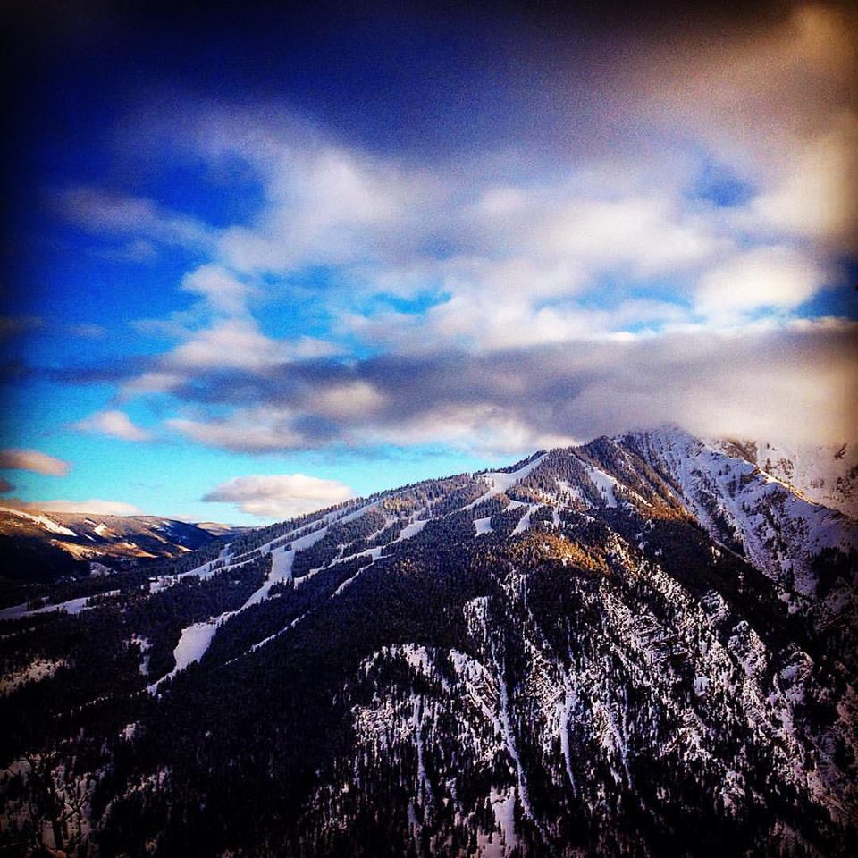 Aspen Highlands ski area at sunset with alpenglow on clouds