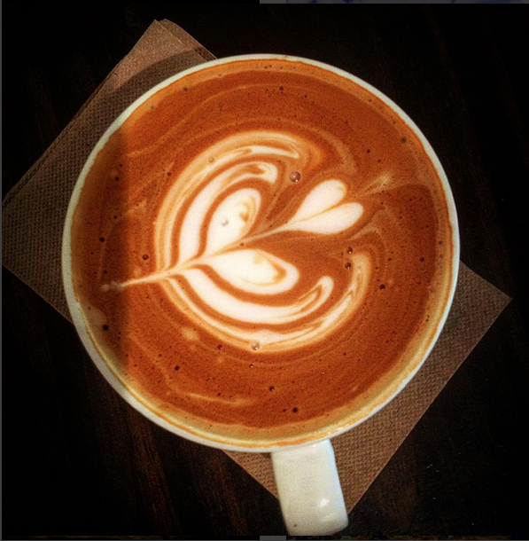 Photo of a latte with flower heart art