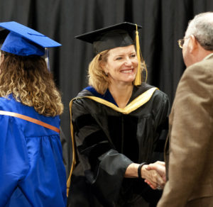 Photo of Colorado Mountain College President and CEO Carrie Besnette Hauser greets nursing graduates and family members at the college's School of Nursing pinning and graduation ceremony on May 7