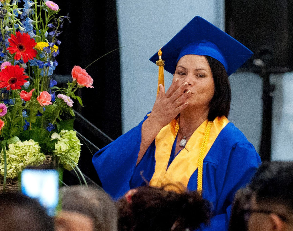 Photo of graduate Rosa Meraz blows a kiss at Colorado Mountain College's associate degree graduation ceremony on May 7 at Spring Valley. Meraz and her 19-year-old daughter, Daniela Santana, graduated together at Spring Valley. Both hope to pursue careers in health care.