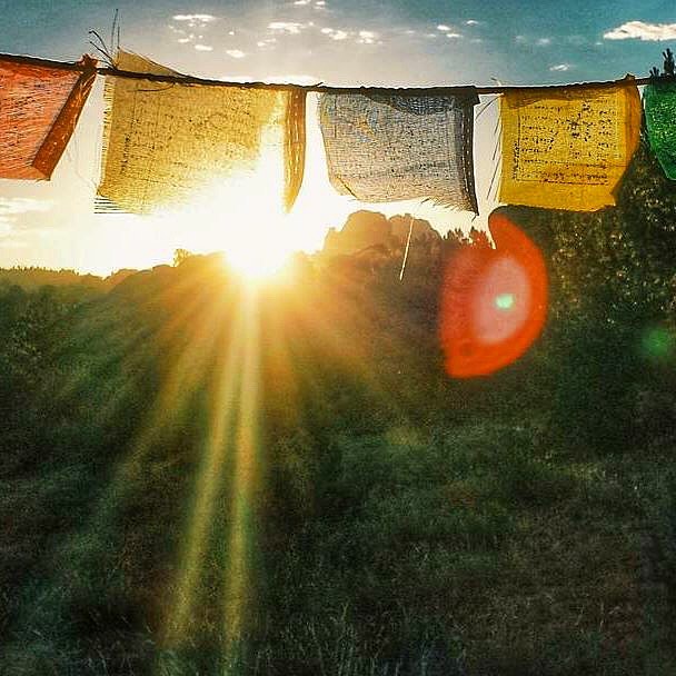 Photo of prayer flags and sunrise