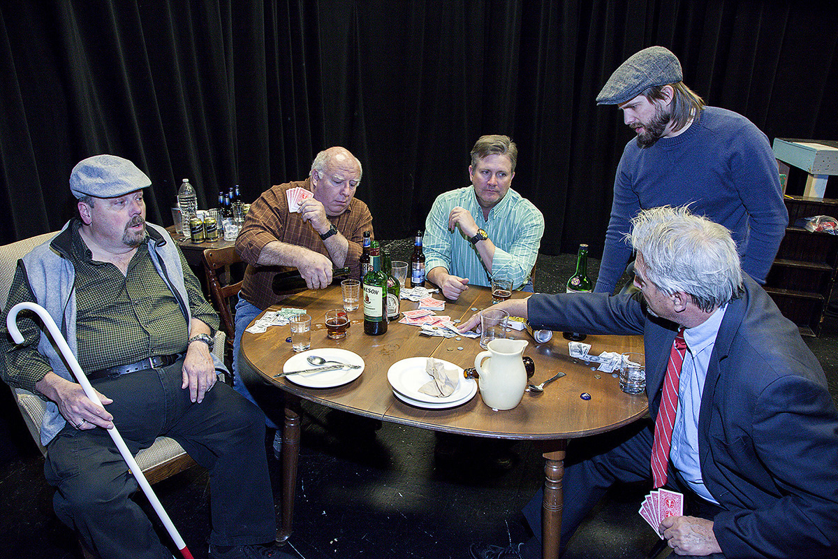 Photo of five actors around table